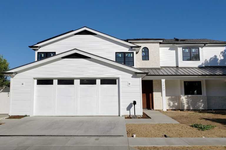 Wayne Dalton Door for Home Rebuild in Newport Beach, CA Wayne Dalton garage door with wood overlay and long panel windows installed for a new home rebuild in Newport Beach, CA.